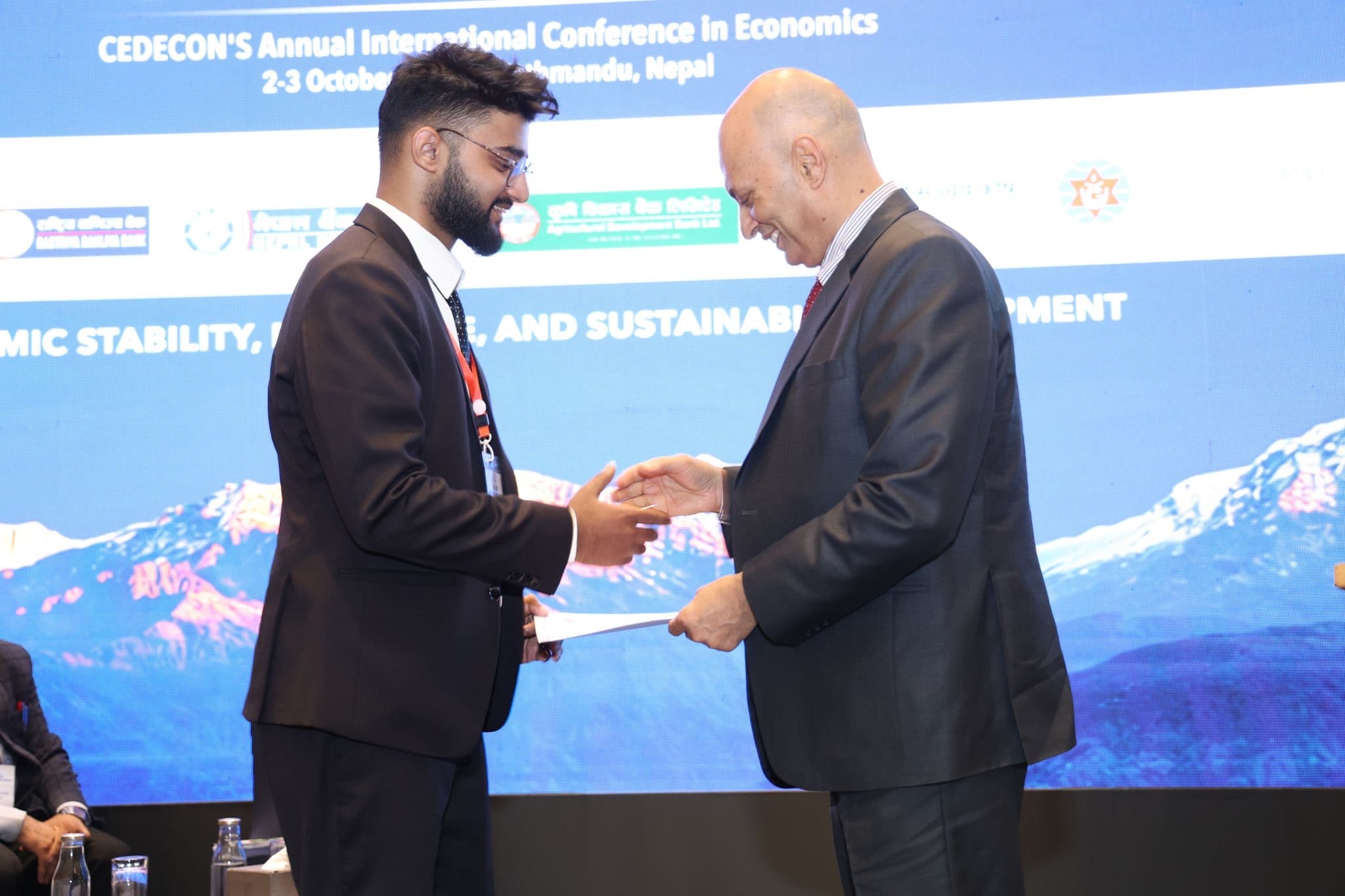 Swostik Nepal being thanked on stage after his presentation at CAICE 2026