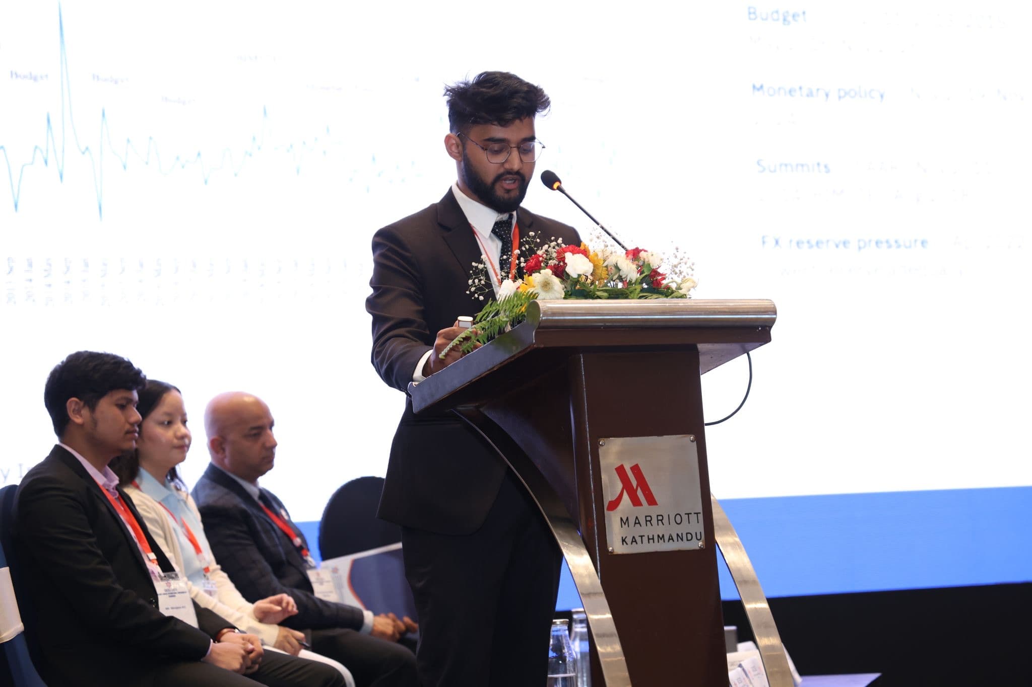 Swostik Nepal speaking at the podium at CAICE 2026 in Kathmandu
